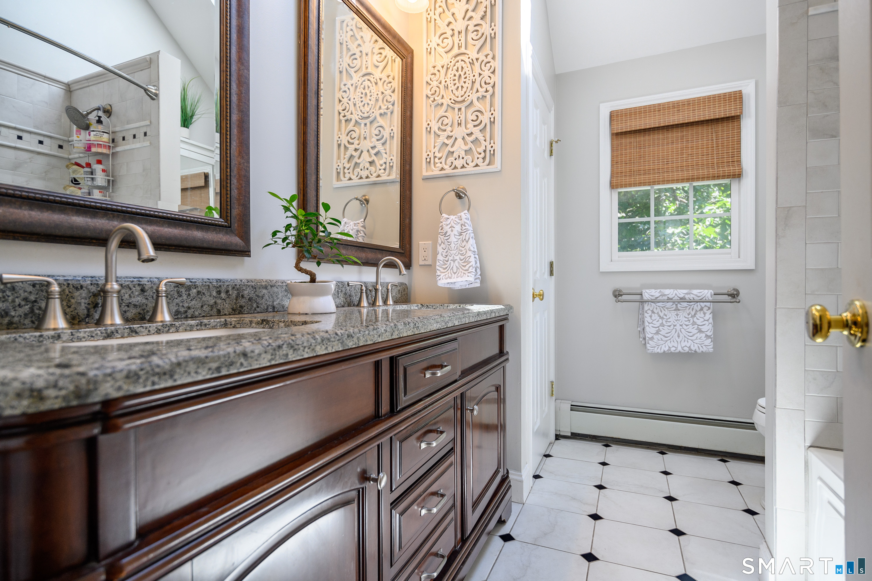 21 Phyllis Lane Newtown, CT 06470 - Photo 21 of 40 Updated bath with granite vanity, decorative wall accents, and tile flooring.