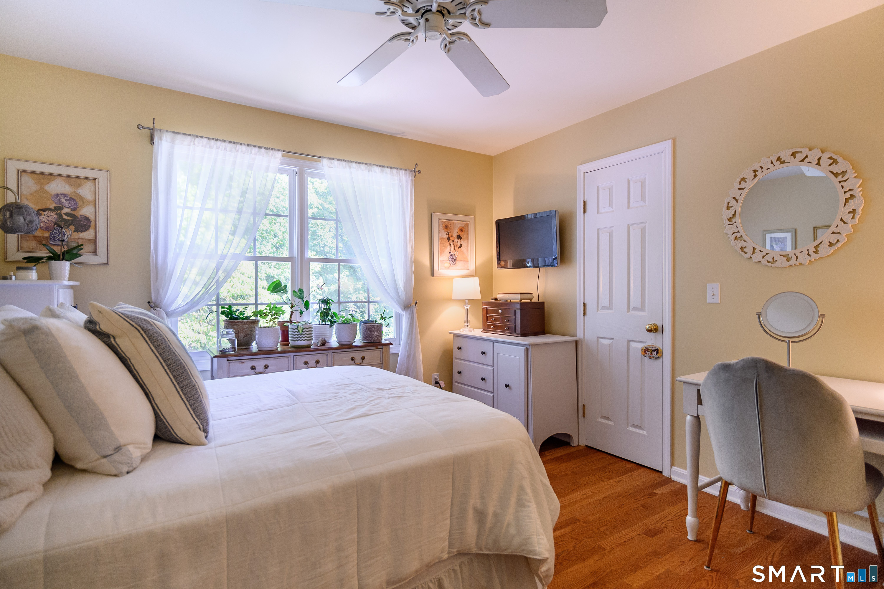 21 Phyllis Lane Newtown, CT 06470 - Photo 23 of 40 Bright bedroom with ceiling fan, hardwood floors, and natural light.