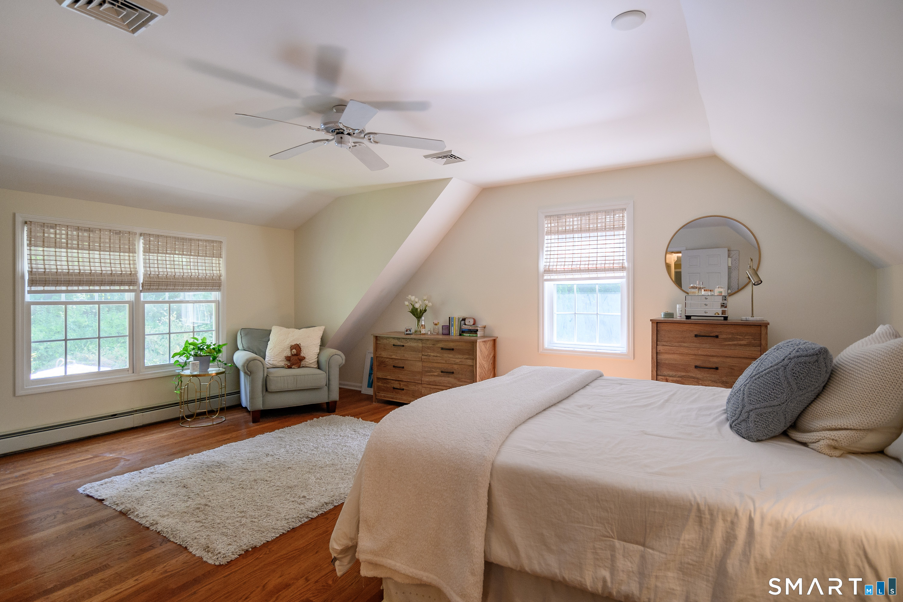21 Phyllis Lane Newtown, CT 06470 - Photo 24 of 40 Spacious bedroom with vaulted ceiling, hardwood floors, and large windows.
