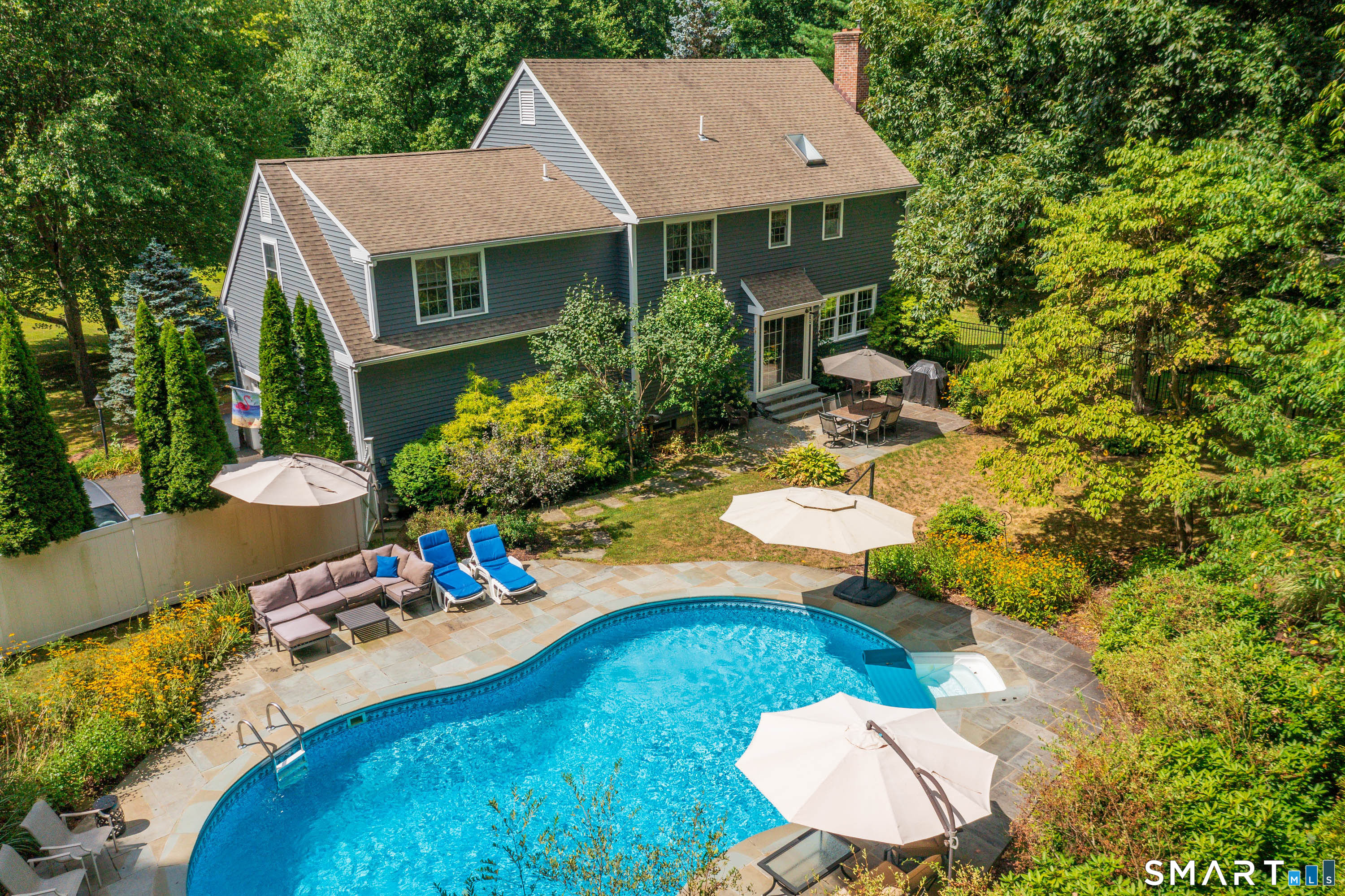21 Phyllis Lane Newtown, CT 06470 - Photo 31 of 40 Aerial view showcasing the backyard oasis with in-ground pool, expansive stone patio, and beautifully landscaped grounds behind the home.