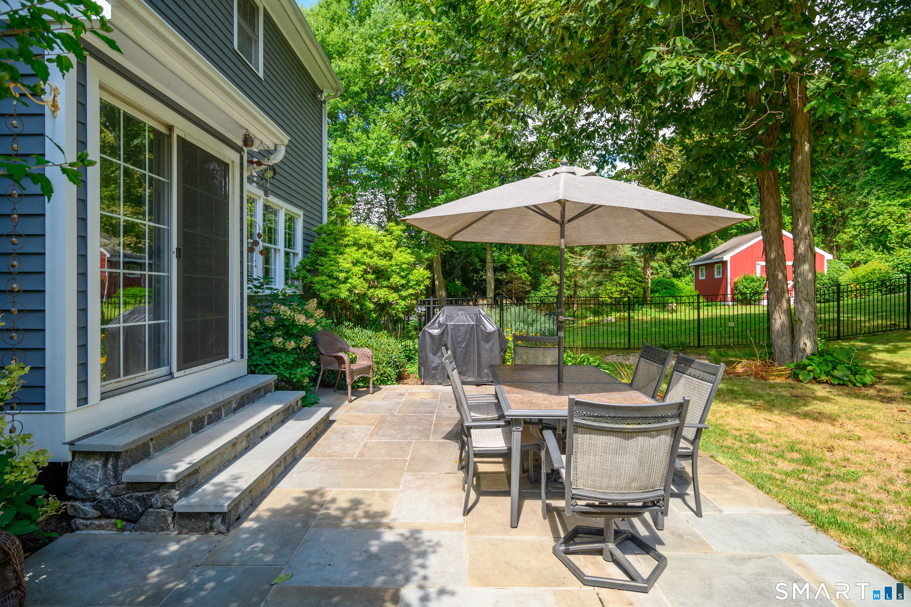 21 Phyllis Lane Newtown, CT 06470 - Photo 35 of 40 Stone patio with outdoor dining area overlooking the pool and gardens.