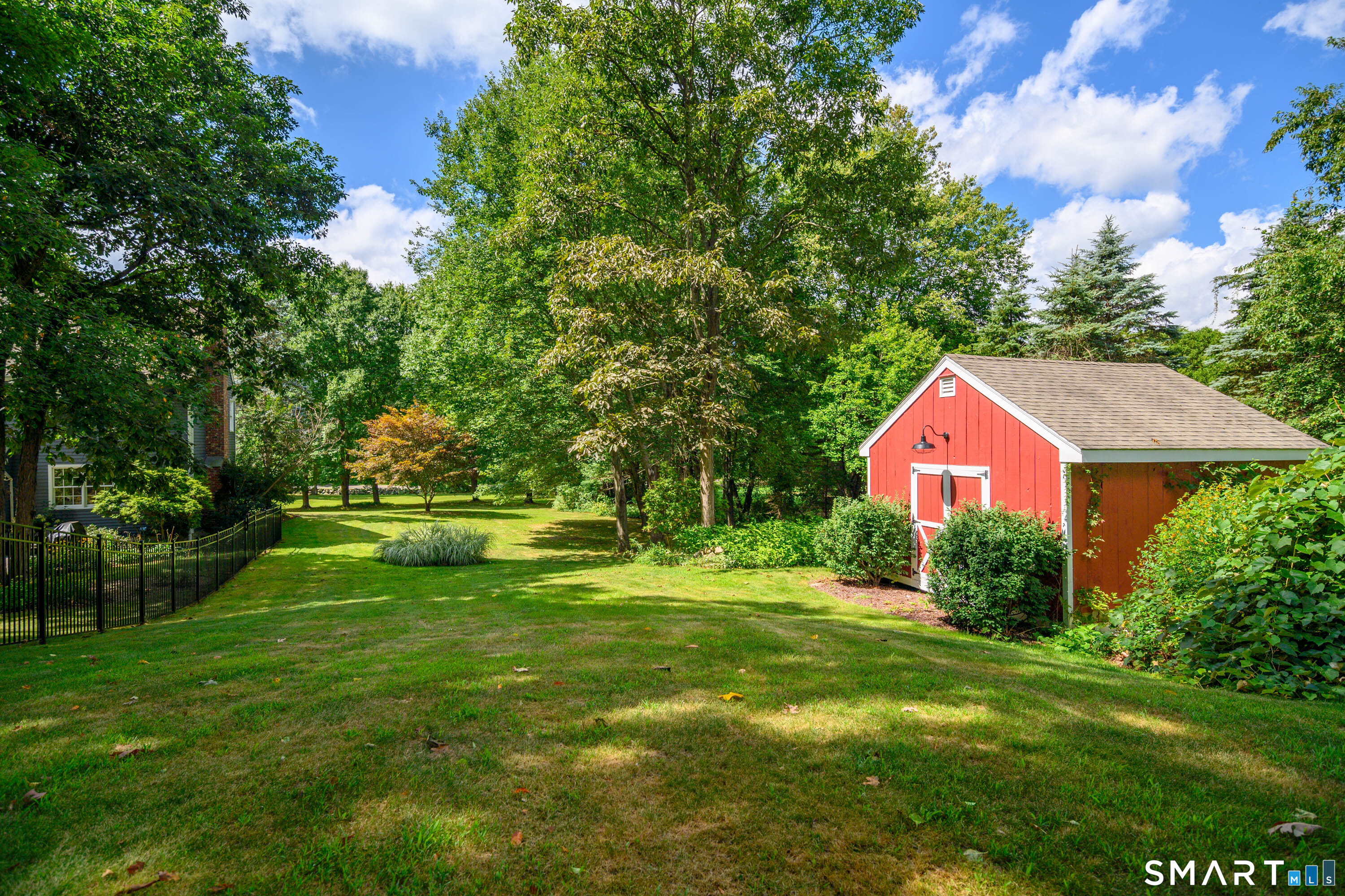 21 Phyllis Lane Newtown, CT 06470 - Photo 38 of 40 Expansive backyard with mature trees and charming red storage shed.