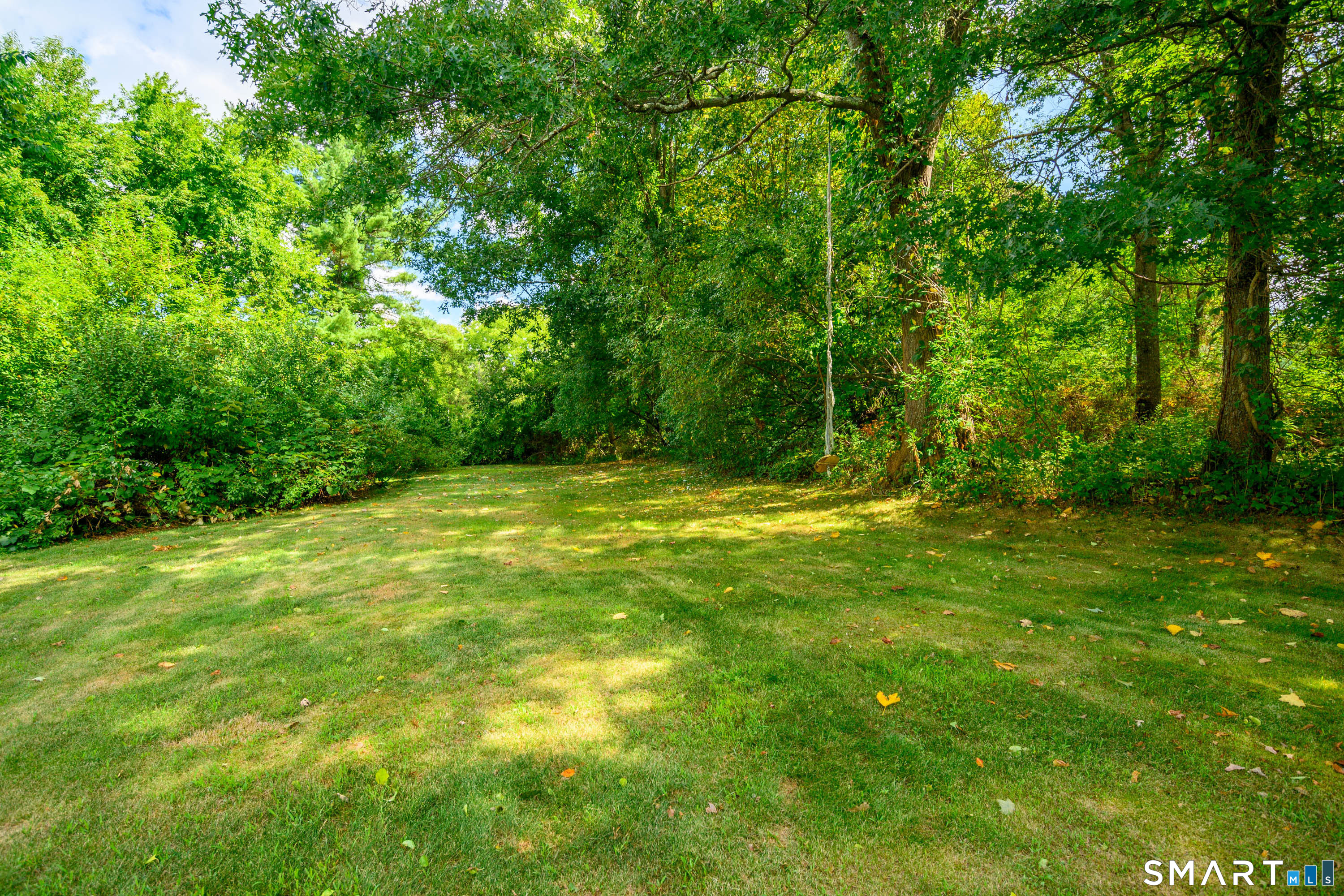 21 Phyllis Lane Newtown, CT 06470 - Photo 39 of 40 Large level lawn bordered by mature trees offering privacy and space to play.