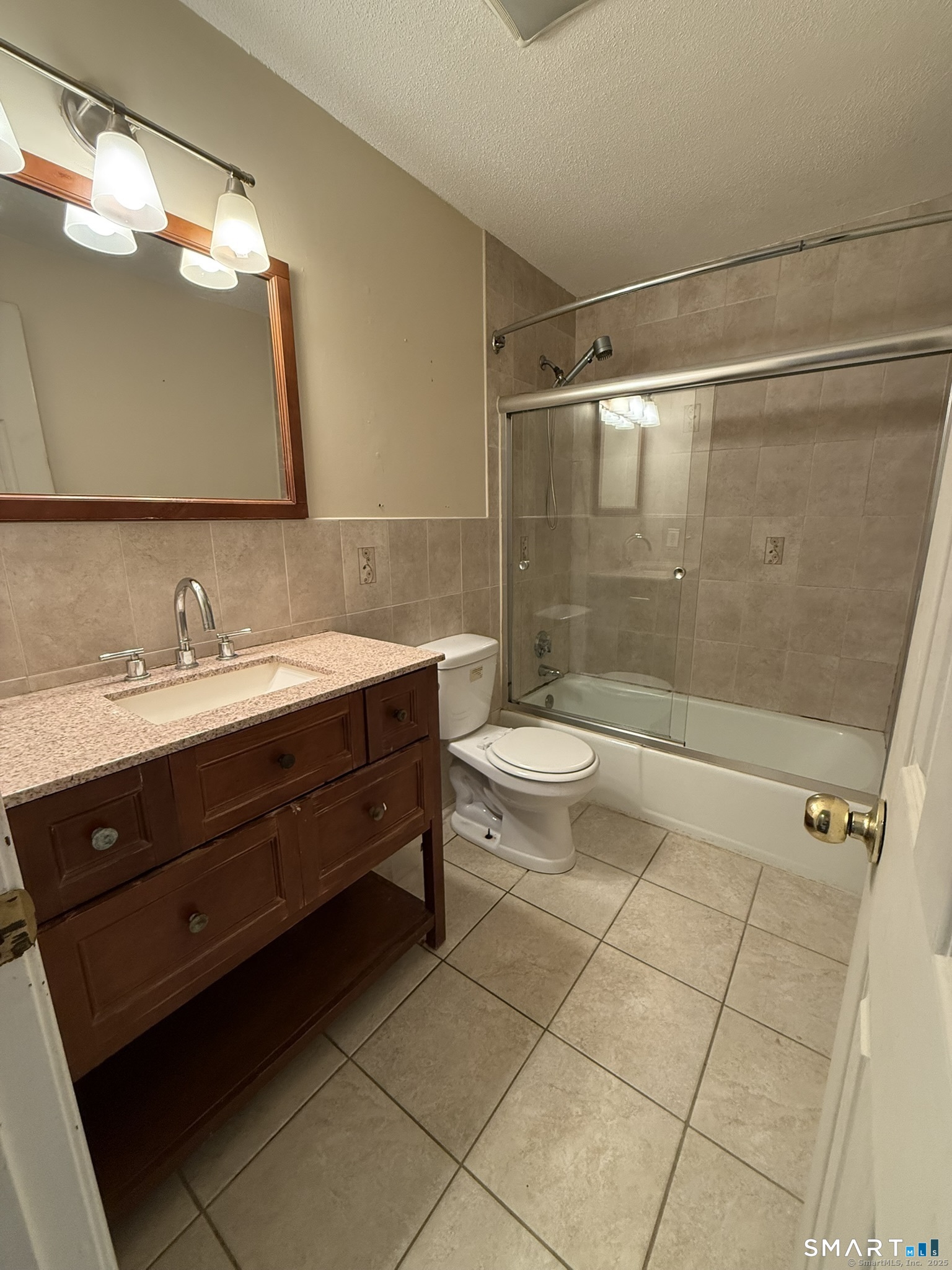 11 King Arthur Drive, Unit 2H East Lyme, CT 06357 - Photo 3 of 10 a bathroom with a sink a toilet and shower