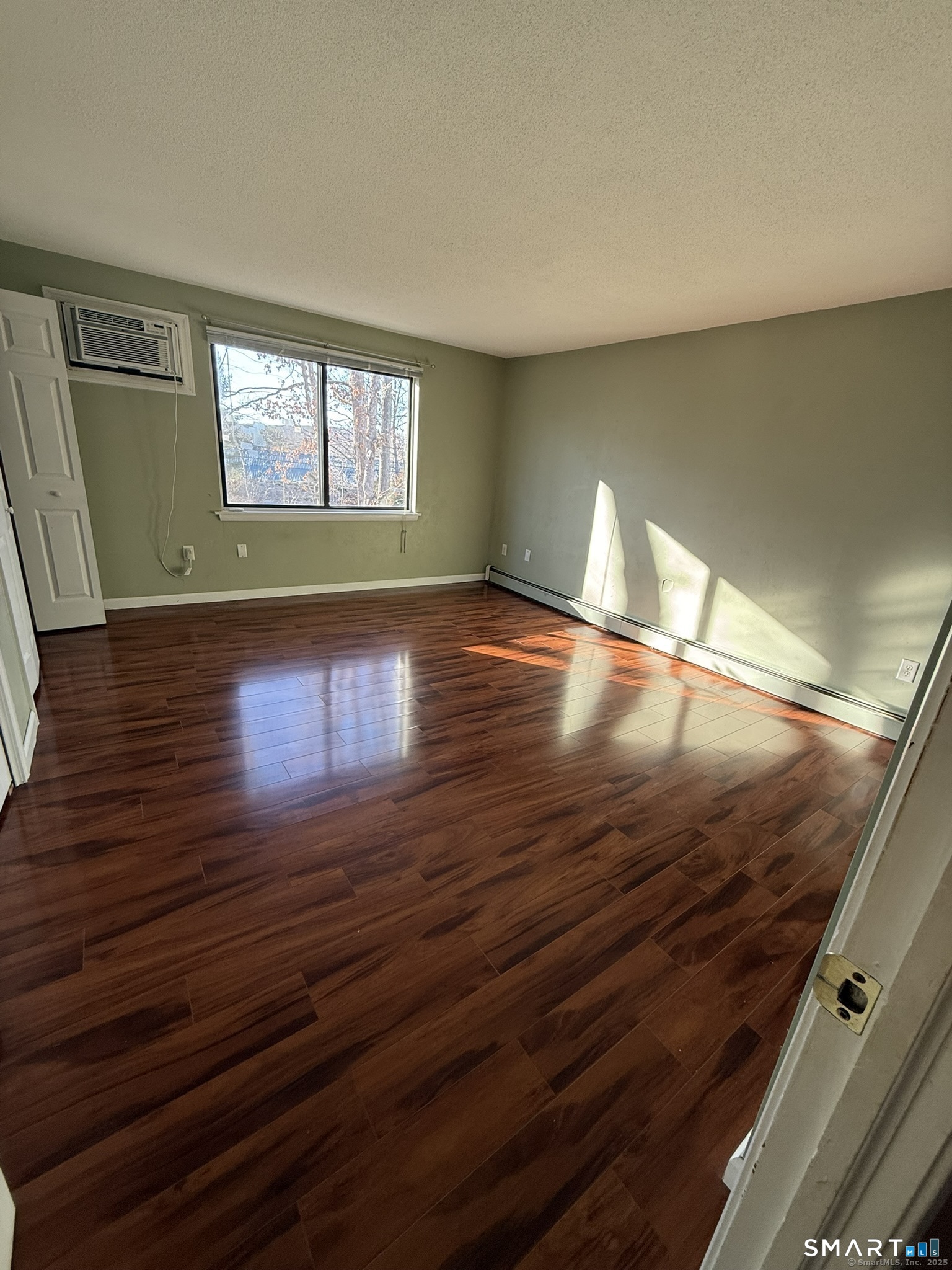 11 King Arthur Drive, Unit 2H East Lyme, CT 06357 - Photo 9 of 10 a view of empty room with window and wooden floor