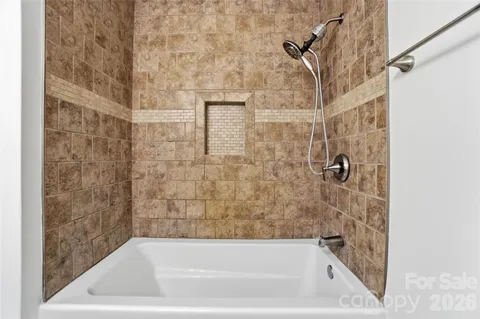 a bath tub sitting next to a shower