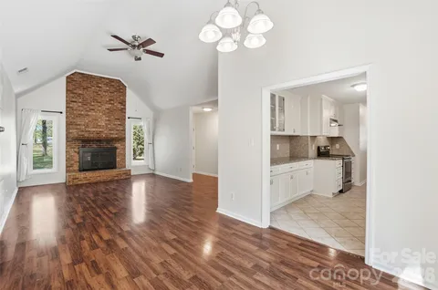 a view of kitchen with cabinets and wooden floor