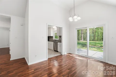 a view of a kitchen with wooden floor and a ceiling fan