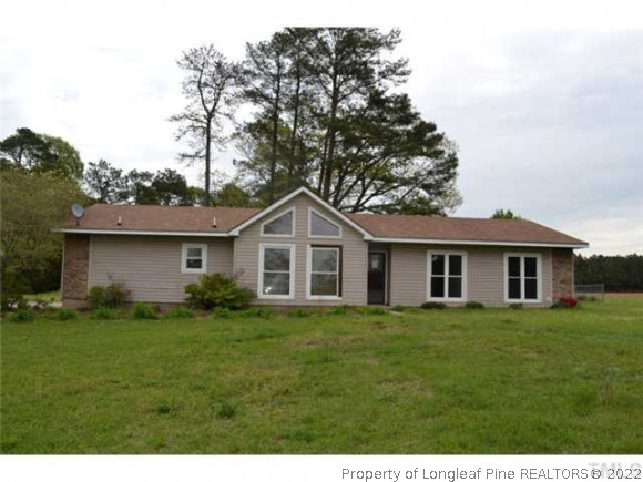 2587 Fairground Road Benson, NC 27504 - Photo 1 of 9 a front view of a house with a garden