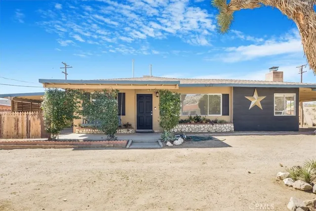 a view of a house with backyard porch and furniture