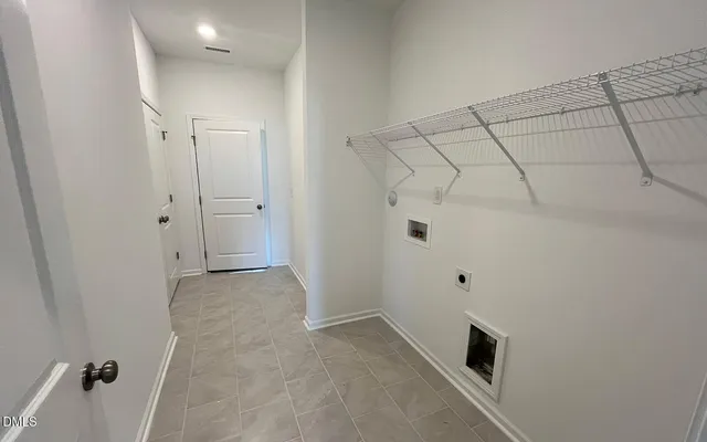 a view of a utility room with racks on the wall