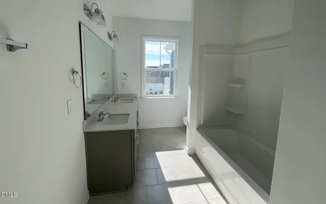 a bathroom with a bathtub and shower