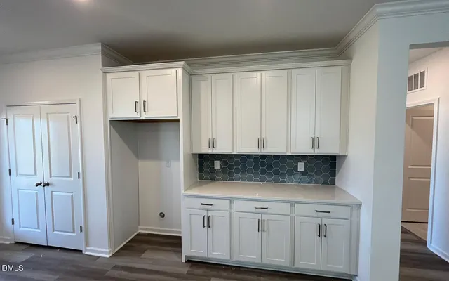 a view of cabinets and wooden floor