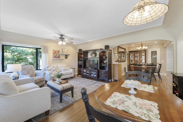 a living room with furniture and a chandelier