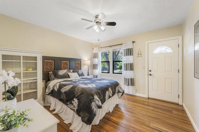 a bedroom with a bed and a chandelier