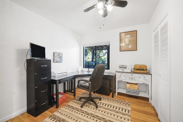 a view of a patio with table and chairs under an umbrella