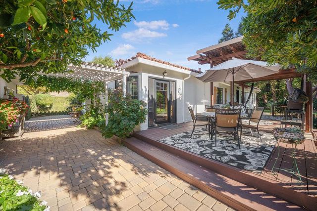 a bedroom with a bed and dresser with mirror