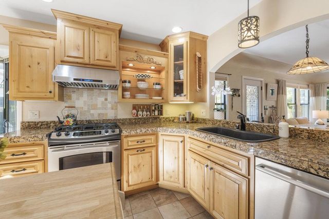 a kitchen with cabinets and stainless steel appliances