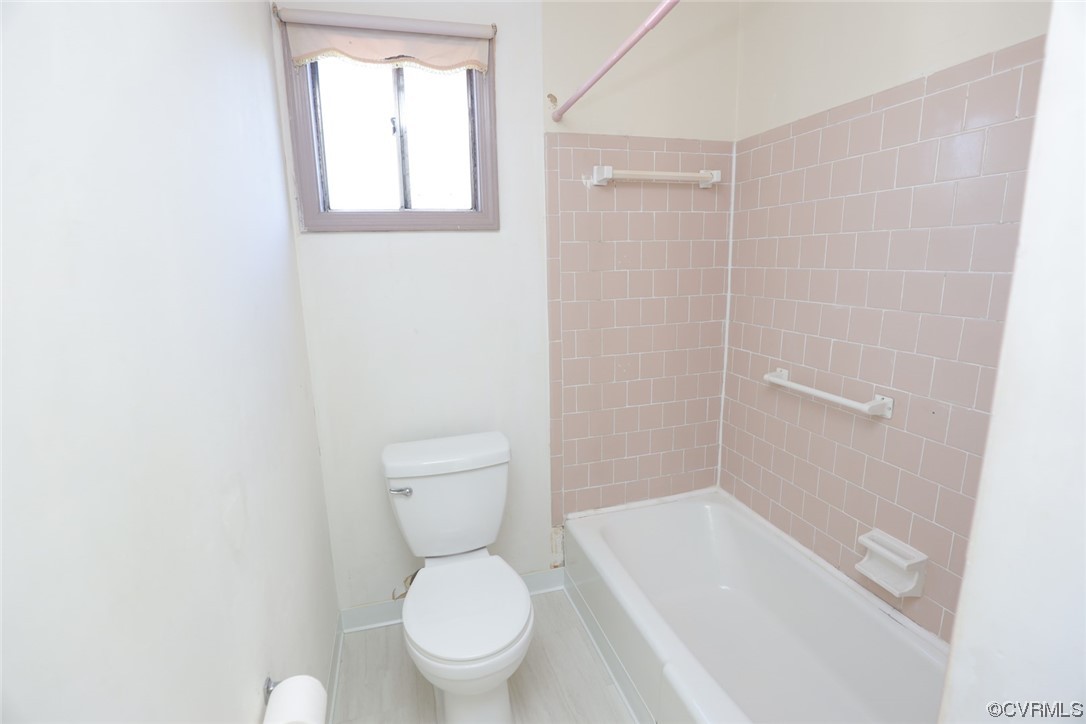 6424 Commander Road Richmond, VA 23224 - Photo 14 of 46 a white toilet sitting next to a bath tub