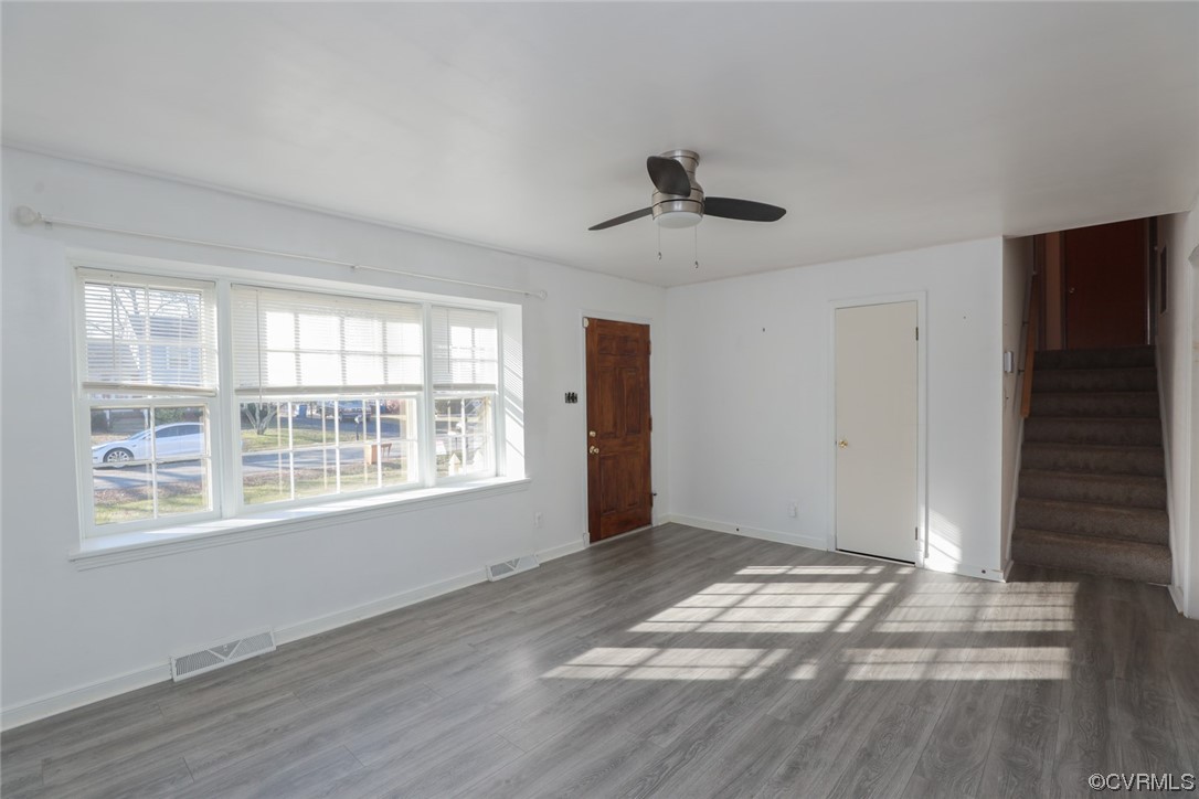 6424 Commander Road Richmond, VA 23224 - Photo 5 of 46 a view of an empty room with a window and wooden floor