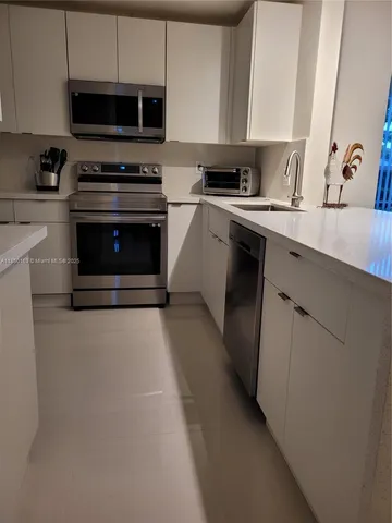 a kitchen with a stove and a microwave