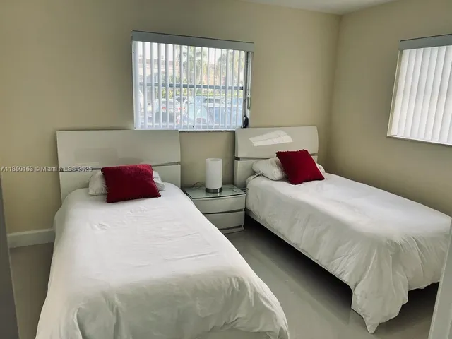 a bedroom with bed and window