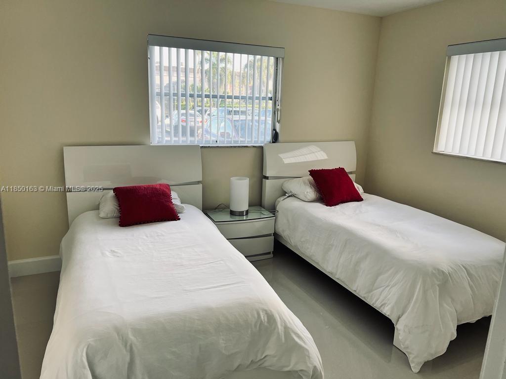8101 Southwest 24th Court, Unit 108 Davie, FL 33324 - Photo 5 of 10 a bedroom with bed and window