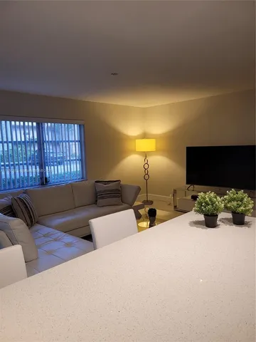 a bed room with furniture and a flat screen tv