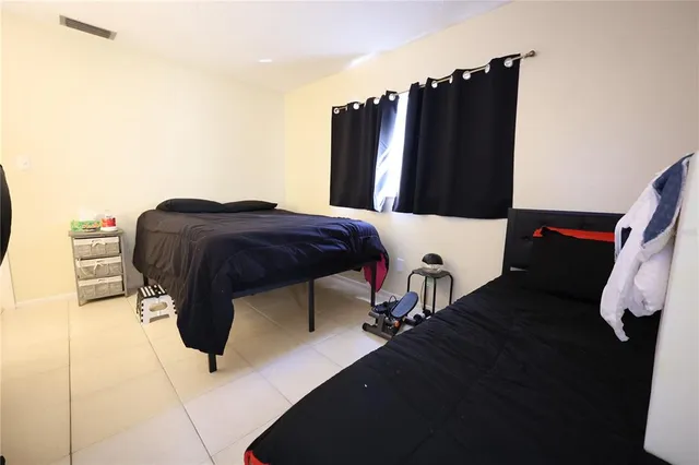 a living room with furniture and a walk fan