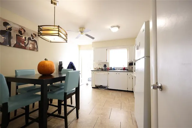 a kitchen with stainless steel appliances granite countertop a sink a stove a refrigerator and cabinets