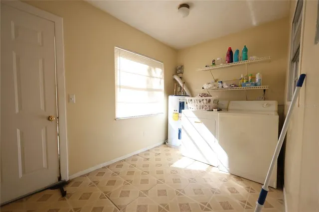 a view of a kitchen with a sink washer and dryer