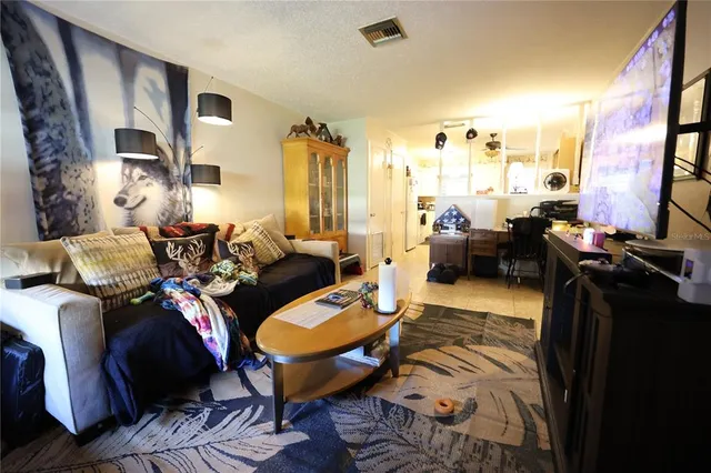 a living room with furniture fireplace and a large window