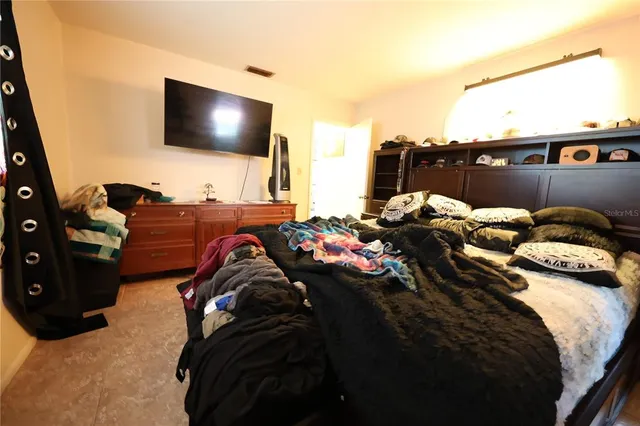 a bed room with two bed and a flat screen tv