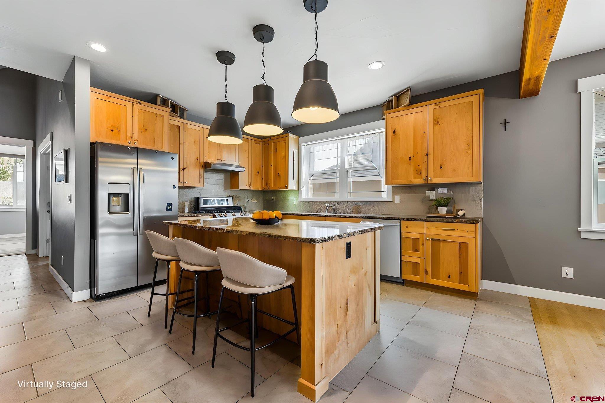 585 Prospector Avenue Durango, CO 81301 - Photo 5 of 28 a kitchen with stainless steel appliances granite countertop a sink a stove and a refrigerator