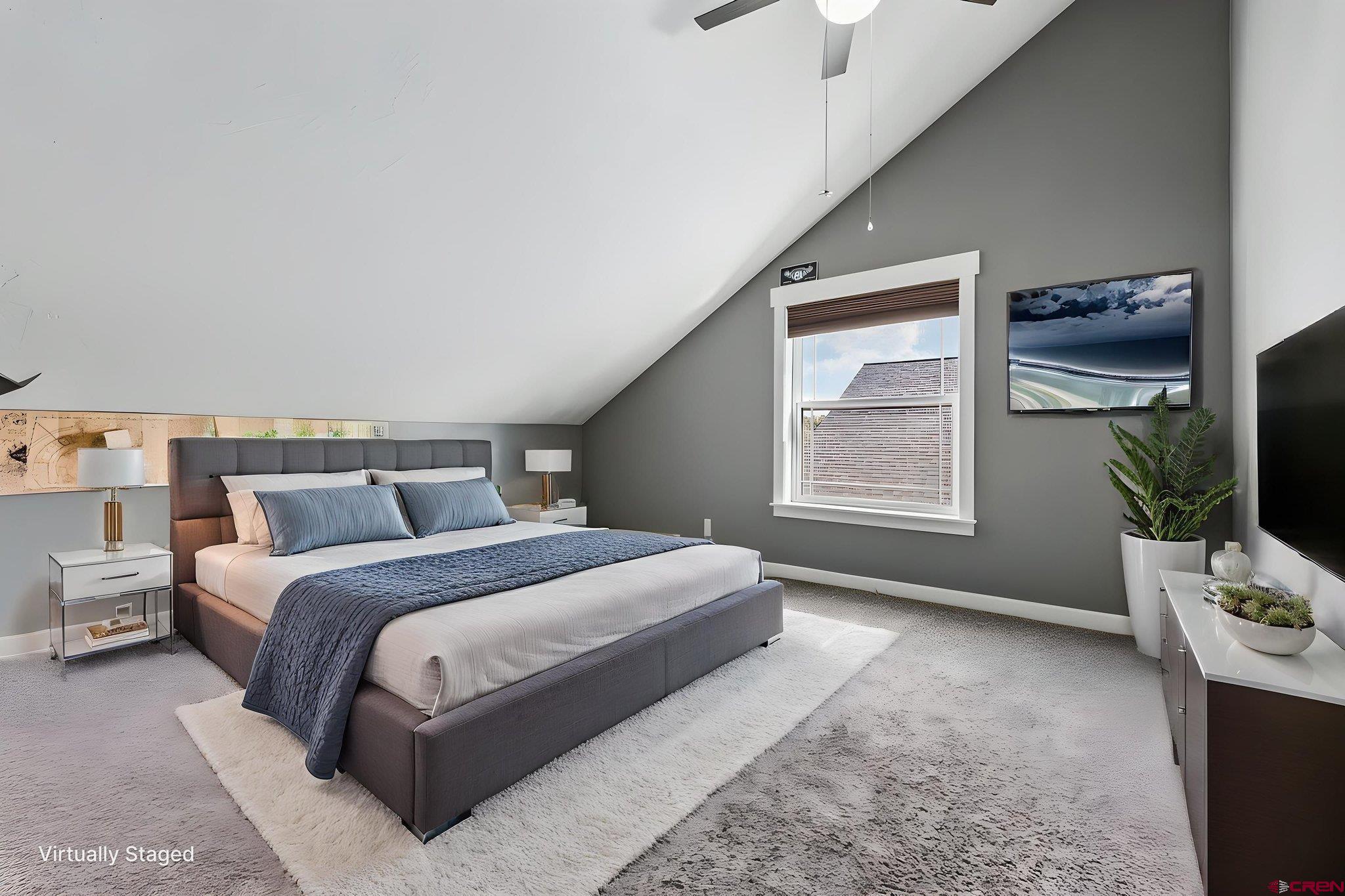 585 Prospector Avenue Durango, CO 81301 - Photo 9 of 28 a spacious bedroom with a bed and a flat screen tv
