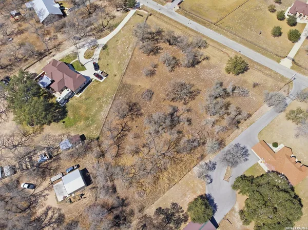 a aerial view of a house with a yard and covered with snow