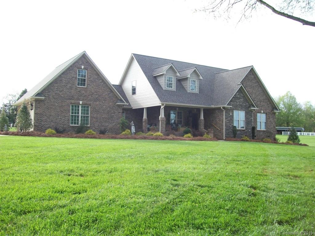 1707 Requa Road Cherryville, NC 28021 - Photo 1 of 24 a front view of a house with a yard and trees