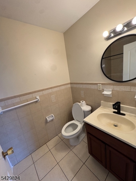 83 Broadway Elizabeth Port, NJ 07206 - Photo 5 of 10 a bathroom with a sink mirror and toilet