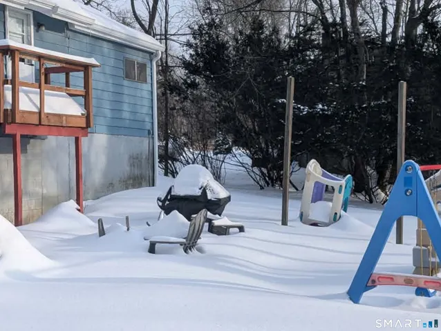 a view of a patio with a table and chairs