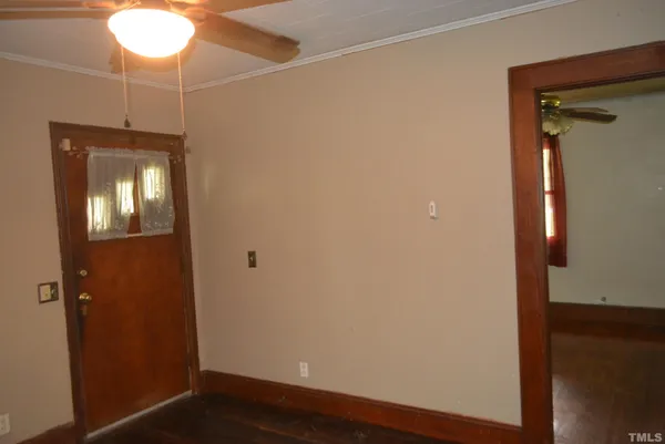 a view of a room with wooden floor