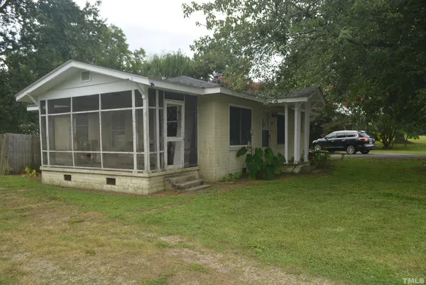 a view of a house with backyard sitting area and garden