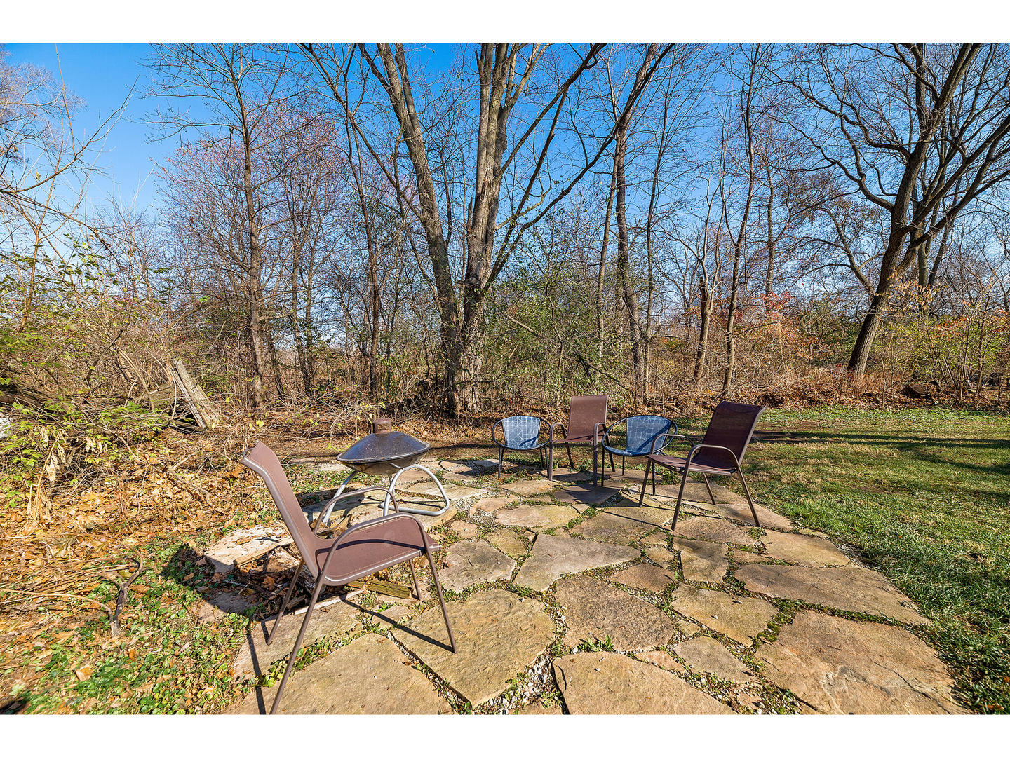 28W414 Batavia Road Warrenville, IL 60555 - Photo 22 of 31 a view of a backyard with table and chairs and a fire pit