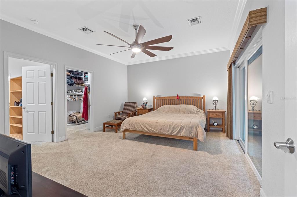 763 Date Palm Lane St. Petersburg, FL 33707 - Photo 15 of 34 a spacious bedroom with a bed and a chandelier