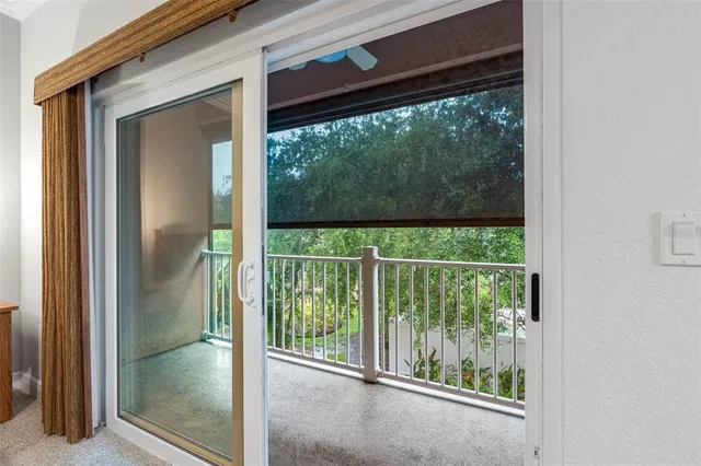 a view of a glass door with a balcony from a room