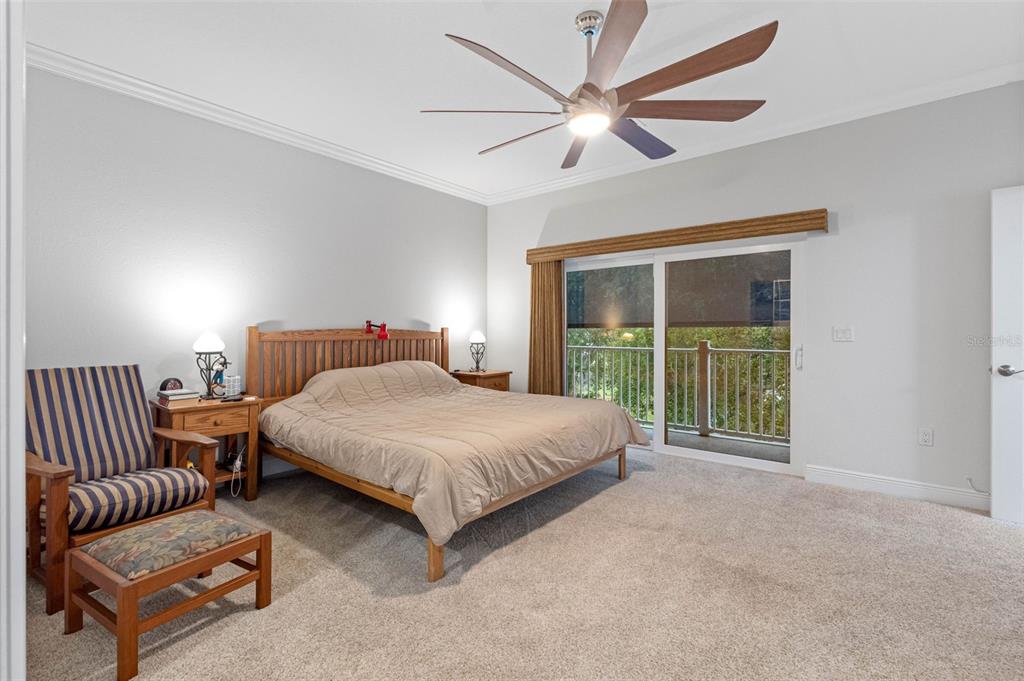 763 Date Palm Lane St. Petersburg, FL 33707 - Photo 17 of 34 a spacious bedroom with a bed and a large window