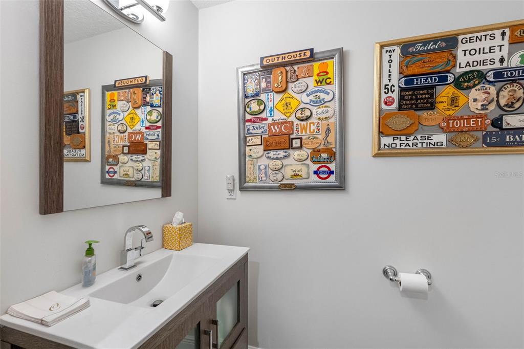 763 Date Palm Lane St. Petersburg, FL 33707 - Photo 9 of 34 a bathroom with a painting on the wall and a sink