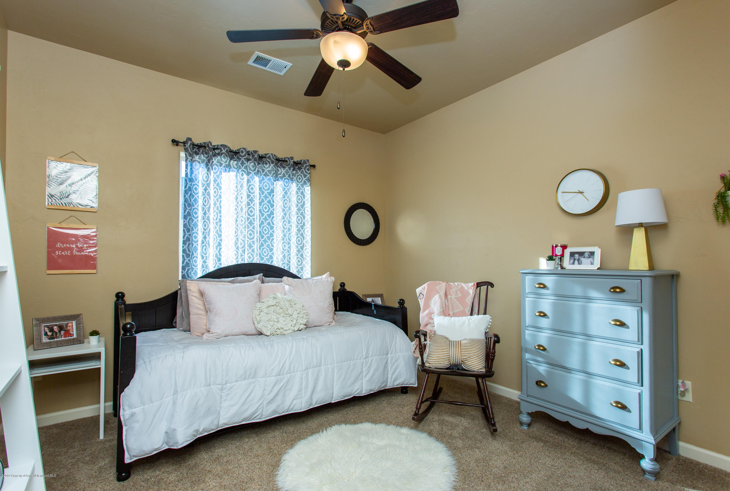 1930 Promontory Circle Rifle, CO 81650 - Photo 12 of 19 a bedroom with a bed and a chandelier