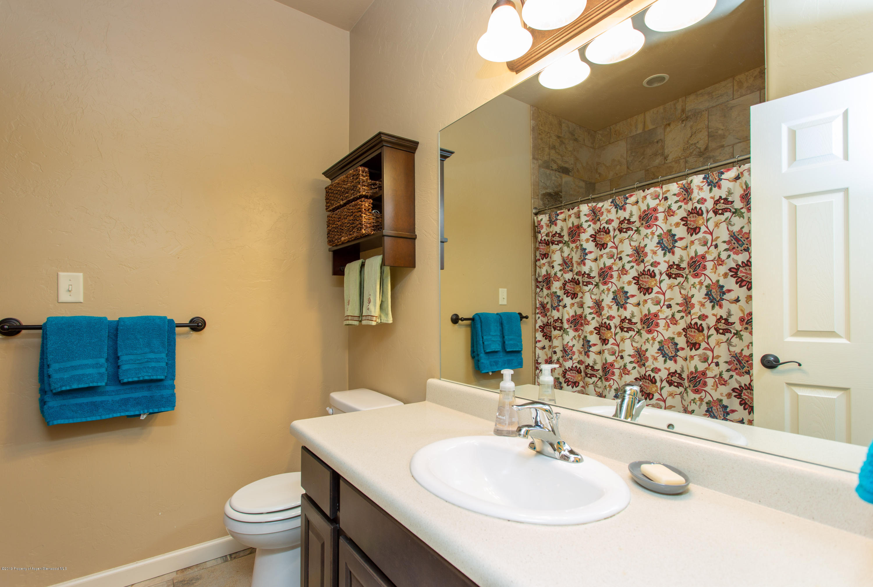 1930 Promontory Circle Rifle, CO 81650 - Photo 14 of 19 a bathroom with a sink and a mirror