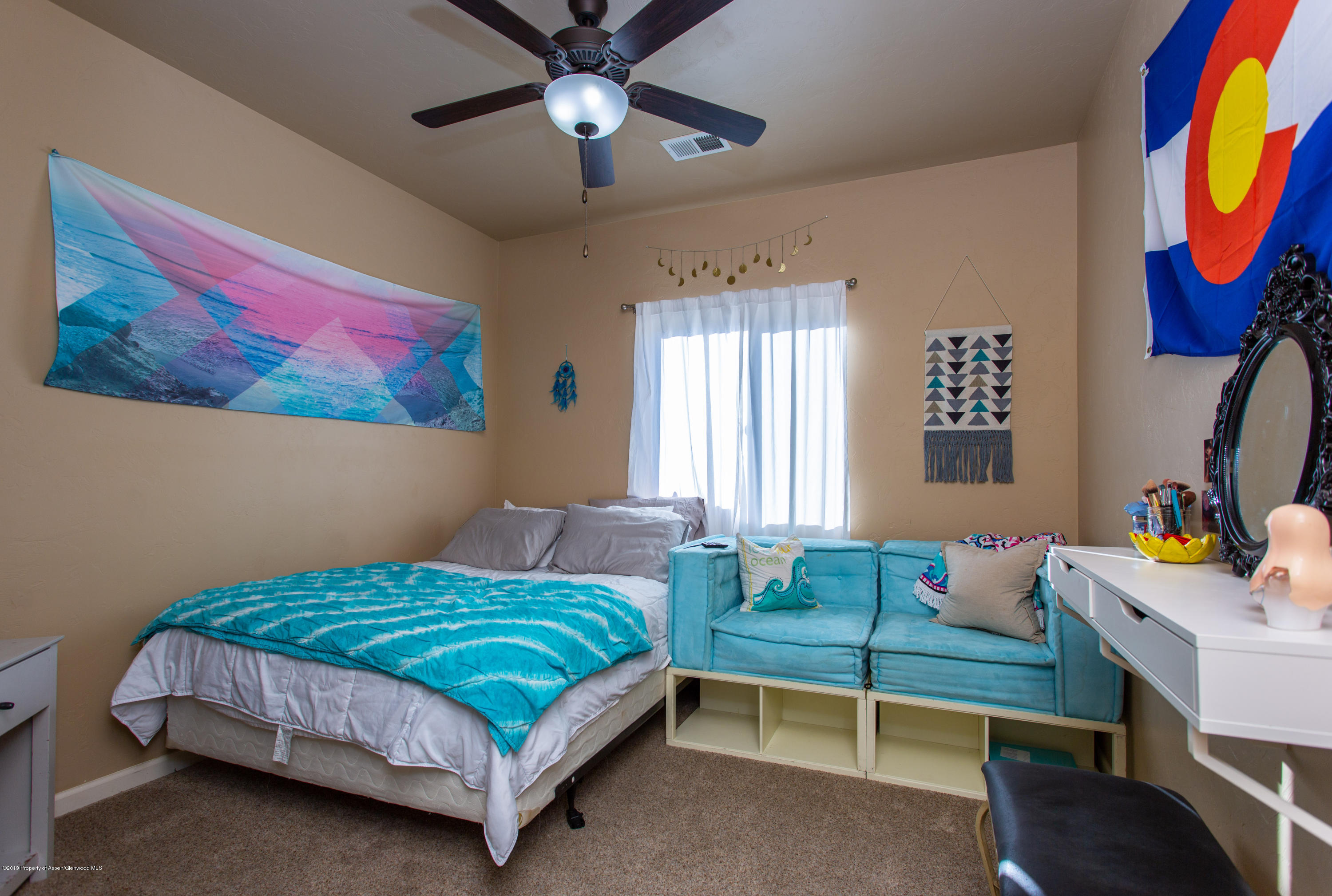 1930 Promontory Circle Rifle, CO 81650 - Photo 15 of 19 a bedroom with a bed and a painting on the wall