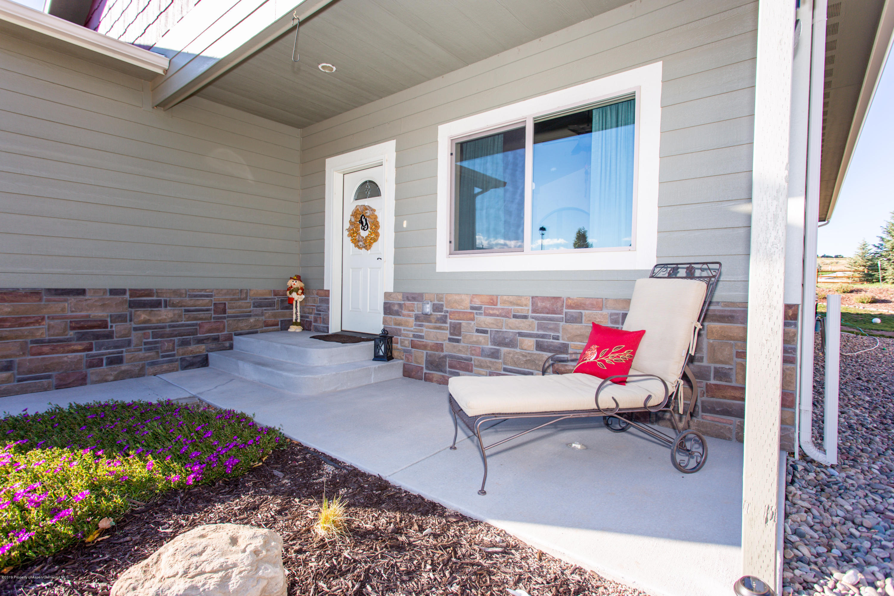 1930 Promontory Circle Rifle, CO 81650 - Photo 2 of 19 a building outdoor space with patio furniture and flowers